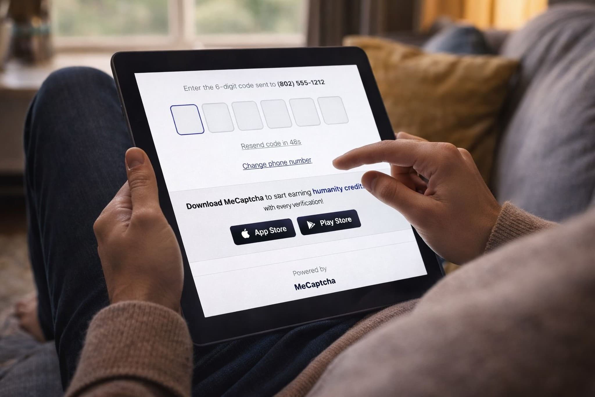 MeCaptcha Verify on tablet: user entering 6-digit code with app download prompt for humanity credits